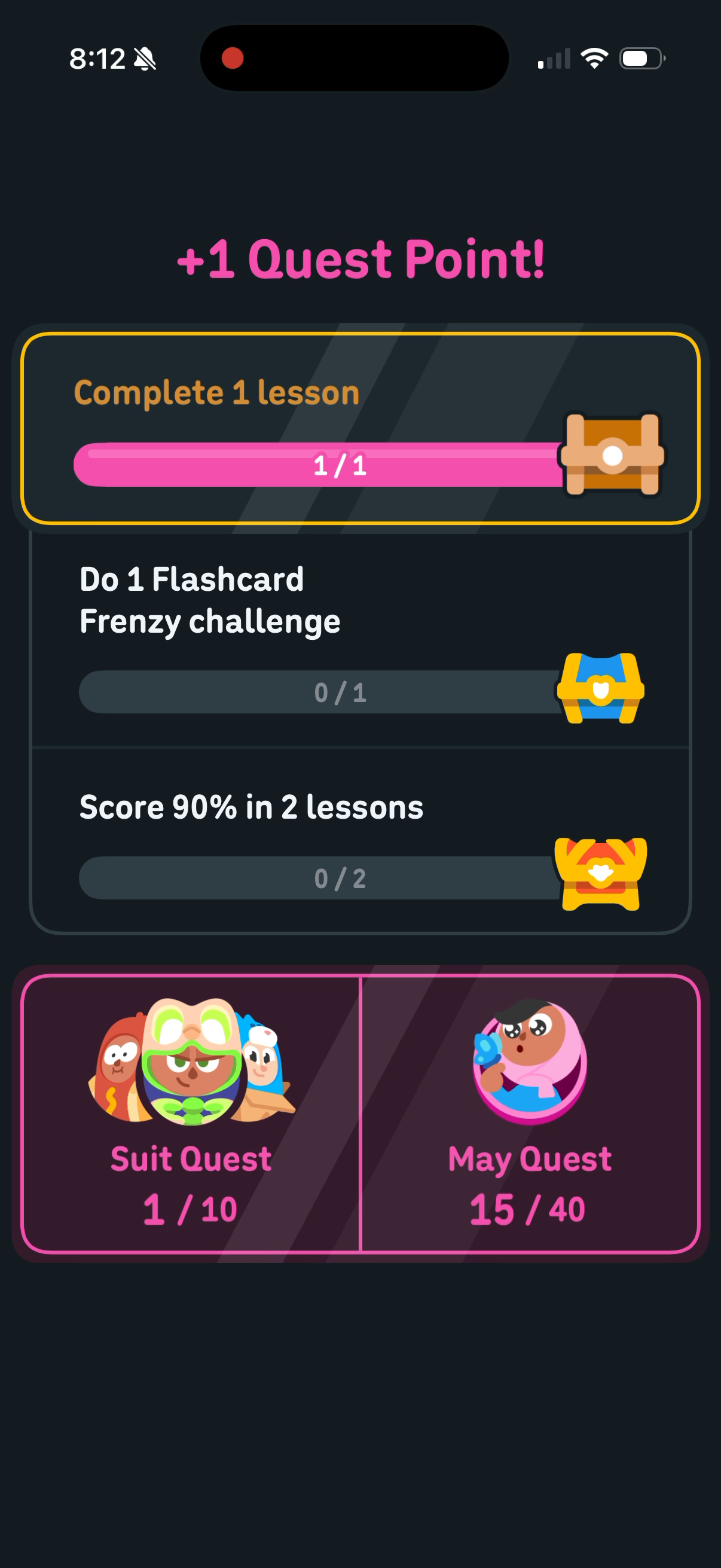 Duolingo post-lesson screen reading "+1 Quest Point!" — the daily quest "Complete 1 lesson" filled at 1 of 1, two more daily quests below it, and two meters side by side: Suit Quest at 1 of 10 and May Quest at 15 of 40
