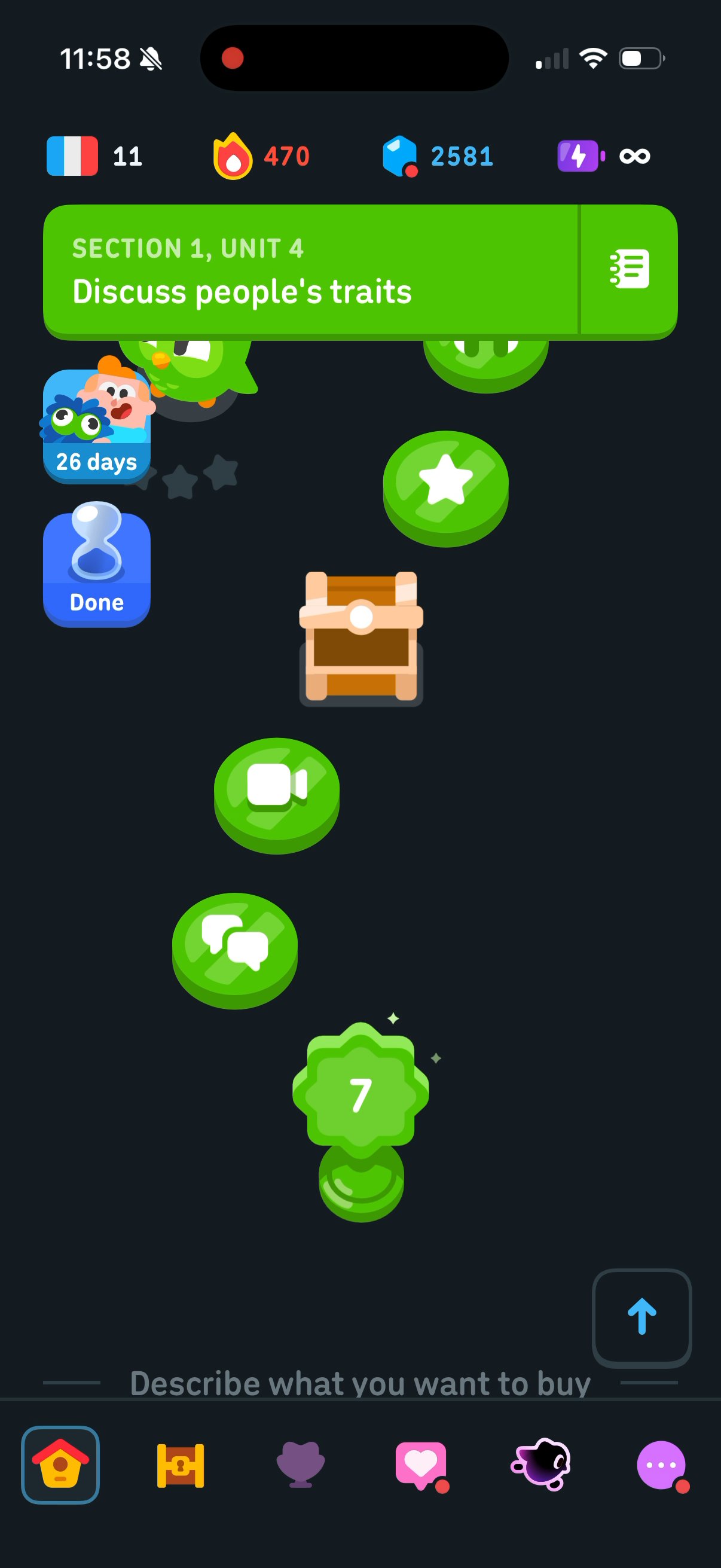 The end of Unit 4 on the Duolingo path — a lesson, then a chest, then two more lessons, then the unit trophy, with a divider below naming the next unit, "Describe what you want to buy"
